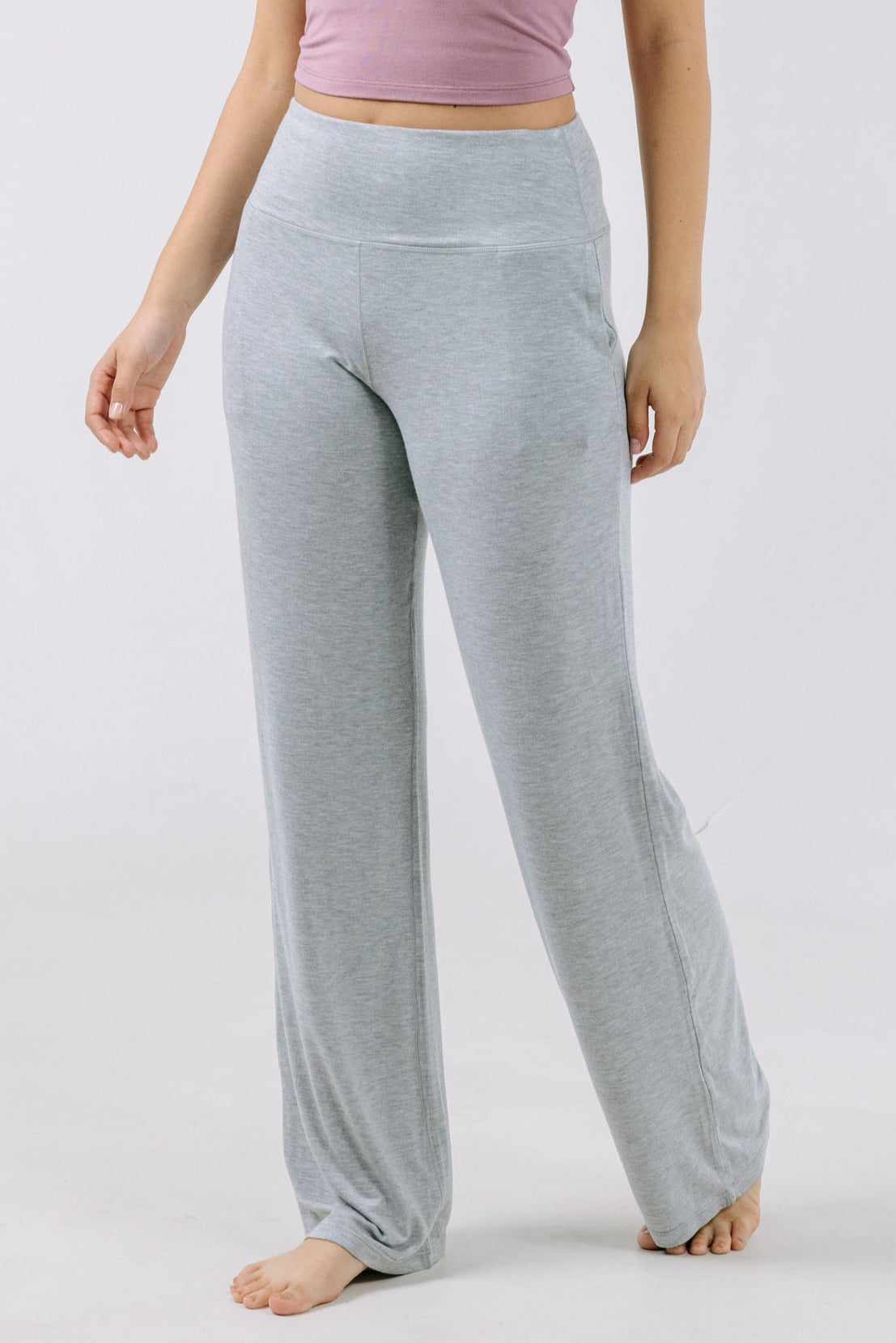Gray pajama pants worn by a person on a white background.